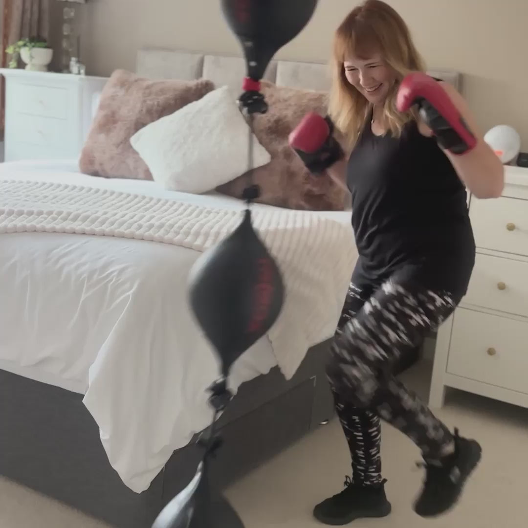 woman kicking and punching ball