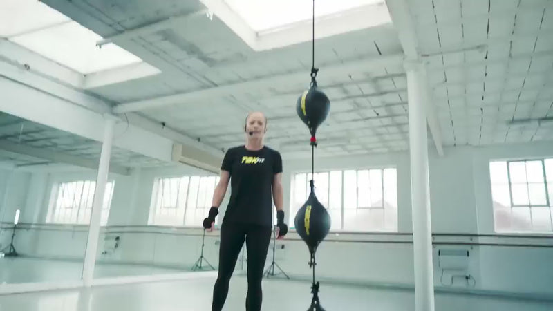 fitness people punching and kicking a punch ball called Triboxking in studio. 